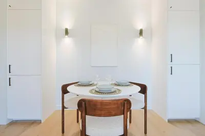 a white table with two chairs and plates on it at L'impérator by Winsome Destination in Cannes