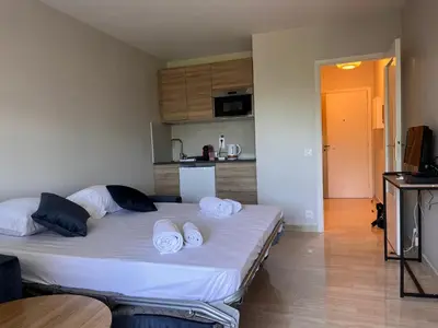 a bedroom with a large bed with towels on it at La douceur de vivre à Cannes in Cannes