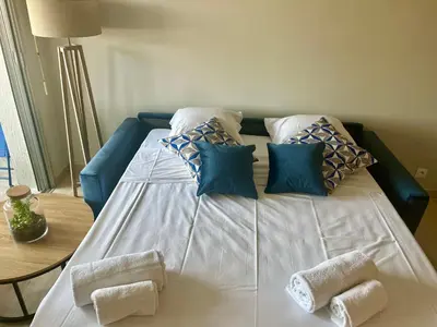 a large white bed with pillows on top of it at La douceur de vivre à Cannes in Cannes