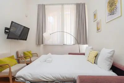 a hotel room with a bed and a tv at IMMOGROOM - Beautiful Duplex - 5 min from the beach - AC - SUQUET in Cannes