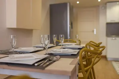 a table with chairs and wine glasses on it at IMMOGROOM - Beautiful Duplex - 5 min from the beach - AC - SUQUET in Cannes