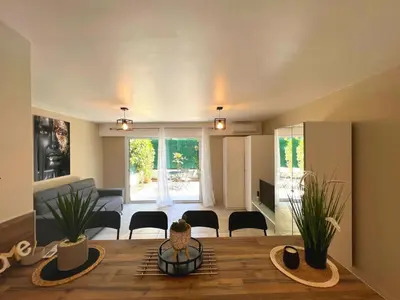 a living room with a dining table and a living room at COSY MADRID, appartement proche de la mer in Cannes