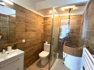 a bathroom with a toilet and a glass shower at COSY MADRID, appartement proche de la mer in Cannes