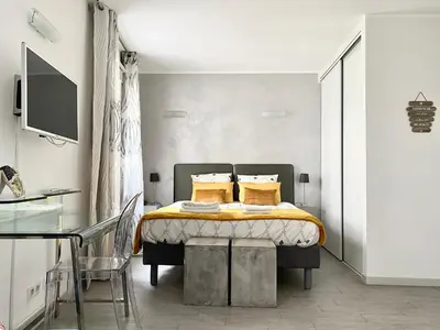 a bedroom with a bed with yellow sheets and yellow pillows at Elegant studio proche Palais des Festivals in Cannes