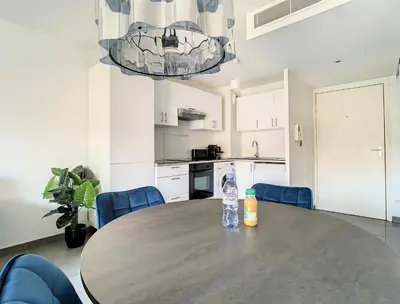 a table in a kitchen with a bottle of water on it at 2p Cannes centre-ville Terrasse in Cannes