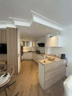 a kitchen with white cabinets and a counter in a room at Cannes : Appartement rénové proche plage in Cannes