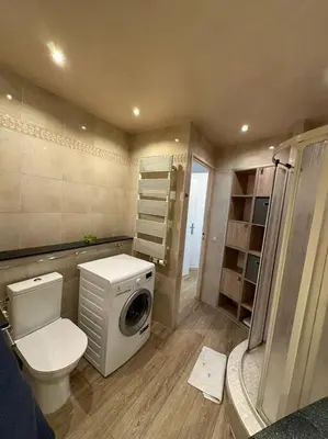 a bathroom with a toilet and a washing machine at Cannes : Appartement rénové proche plage in Cannes