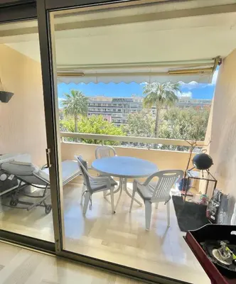 a balcony with a table and chairs and a view at Appartement cannes Croisette in Cannes