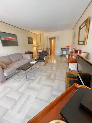 a living room with a couch and a table at Appartement cannes Croisette in Cannes