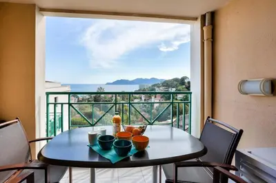 a table with a view of the ocean from a balcony at Résidence Cannes Villa Francia - maeva Home - Appartement vue mer 3 pièces 6 personnes - Prestige MAE-9674 in Cannes