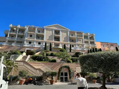 a man taking a picture of a large building at Beau T2 avec terrasse vue mer in Cannes