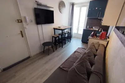 a living room with a couch and a kitchen at WE CANNES ! Cocoon Duplex in dowtown in Cannes
