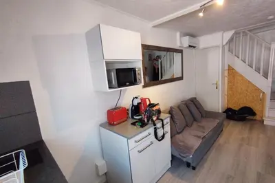 a small living room with a couch and a microwave at WE CANNES ! Cocoon Duplex in dowtown in Cannes