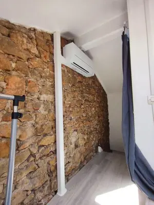 a room with a stone wall and an air conditioner at WE CANNES ! Cocoon Duplex in dowtown in Cannes