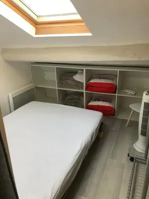 a small bedroom with a bed and a skylight at WE CANNES ! Cocoon Duplex in dowtown in Cannes