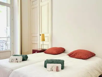 a white room with two beds and a fireplace at L'Imperial - Magnifique Appartement Cannes 5 chambres in Cannes