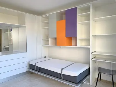 two blue chairs and a table in a room at Studio front de mer, 30M2 Piscine & Mer in Cannes
