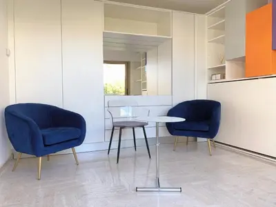 a sauna with wooden walls and wooden shelves at Studio front de mer, 30M2 Piscine & Mer in Cannes