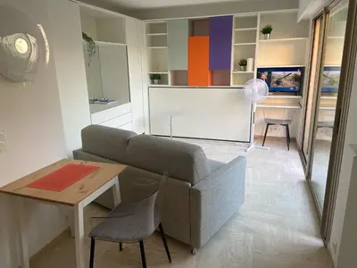 a white bathroom with a sink and a mirror at Studio front de mer, 30M2 Piscine & Mer in Cannes