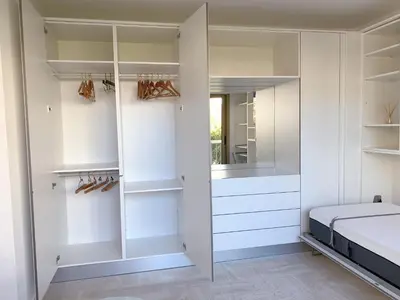 a wooden closet with wooden shelves in a bathroom at Studio front de mer, 30M2 Piscine & Mer in Cannes