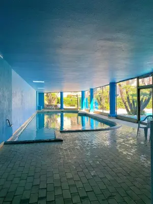 a dining room with a table and a chair at Studio front de mer, 30M2 Piscine & Mer in Cannes