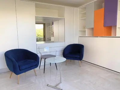 a living room with a couch and a bed at Studio front de mer, 30M2 Piscine & Mer in Cannes