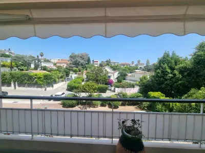 a balcony with a view of a park at Appartement Beauvallon in Cannes