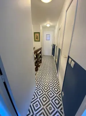 a hallway with a tile floor in a bathroom at Quiet sea view with pool in Cannes