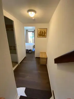 a hallway with a room with a bed and a room with a hallway at Quiet sea view with pool in Cannes