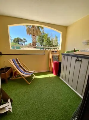 a room with green carpet and a chair and a window at Quiet sea view with pool in Cannes