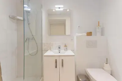 a white bathroom with a sink and a shower at LE MIMONT studio central et calme, séjours en couple ou congrès in Cannes