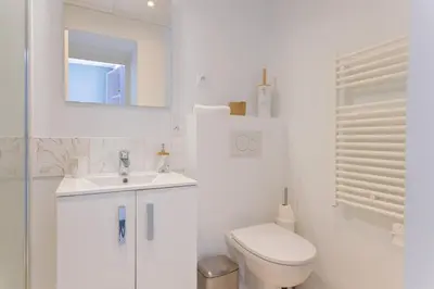 a white bathroom with a toilet and a sink at LE MIMONT studio central et calme, séjours en couple ou congrès in Cannes