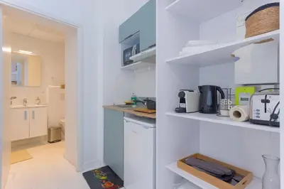 a kitchen with white walls and a white counter top at LE MIMONT studio central et calme, séjours en couple ou congrès in Cannes