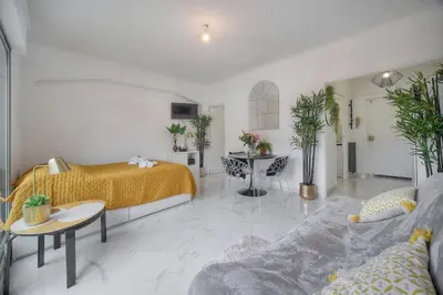 a bedroom with a bed and a couch and a table at Lumineux Studio TERRASSE, Clémenceau-CANNES CENTRE A0B192 in Cannes