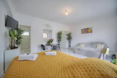 a bedroom with a large yellow bed with towels on it at Lumineux Studio TERRASSE, Clémenceau-CANNES CENTRE A0B192 in Cannes