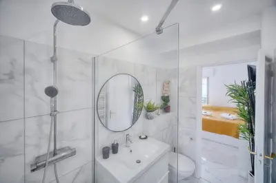 a bathroom with a shower and a sink and a mirror at Lumineux Studio TERRASSE, Clémenceau-CANNES CENTRE A0B192 in Cannes