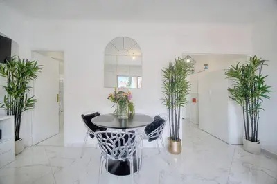 a white room with a table with plants on it at Lumineux Studio TERRASSE, Clémenceau-CANNES CENTRE A0B192 in Cannes