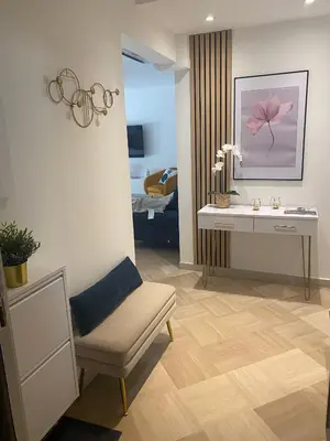 a room with a chair and a desk and a bed at Elegant apartment close to Croisette and Palais de Festival with garage in Cannes