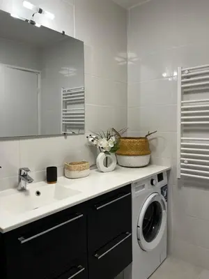 a bathroom with a washing machine and a sink at Elegant apartment close to Croisette and Palais de Festival with garage in Cannes