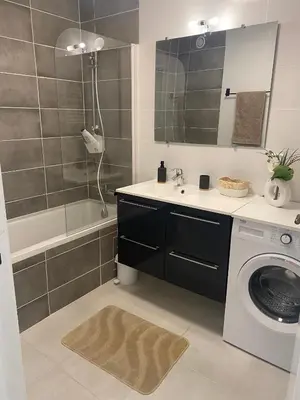 a bathroom with a sink and a washing machine at Elegant apartment close to Croisette and Palais de Festival with garage in Cannes