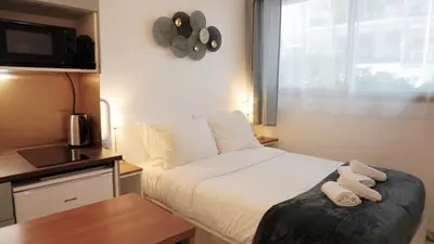 a bedroom with a bed with two towels on it at Proche Croisette, Studio moderne by Palmazur Vacances in Cannes