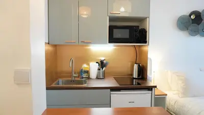 a small kitchen with a sink and a microwave at Proche Croisette, Studio moderne by Palmazur Vacances in Cannes