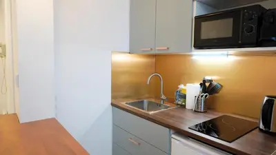 a small kitchen with a sink and a microwave at Proche Croisette, Studio moderne by Palmazur Vacances in Cannes