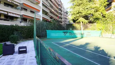 a tennis court in front of a building at Proche Croisette, Studio moderne by Palmazur Vacances in Cannes