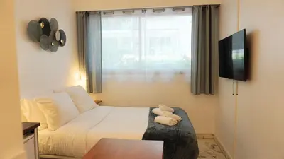 a small bedroom with a bed and a window at Proche Croisette, Studio moderne by Palmazur Vacances in Cannes