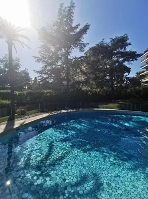 a swimming pool filled with lots of blue water at 2 bedrooms seafront in Cannes