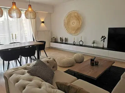 a living room with a couch and a table at 2 bedrooms seafront in Cannes