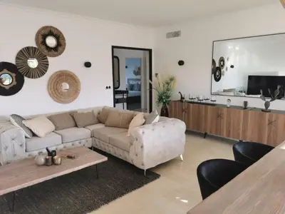 a living room with a couch and a table at 2 bedrooms seafront in Cannes