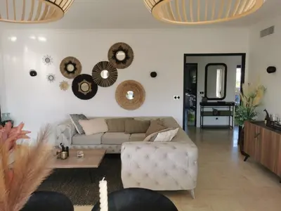 a living room with a couch and mirrors on the wall at 2 bedrooms seafront in Cannes