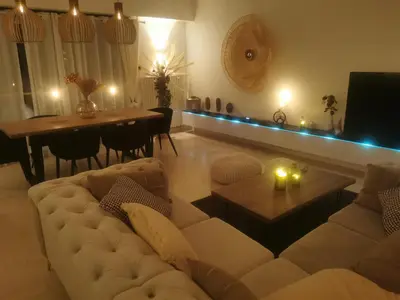 a living room with a white couch and a table at 2 bedrooms seafront in Cannes